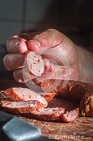 Sliced â€‹â€‹smoked calabrese sausage in a wooden table,copy space Stock Photo